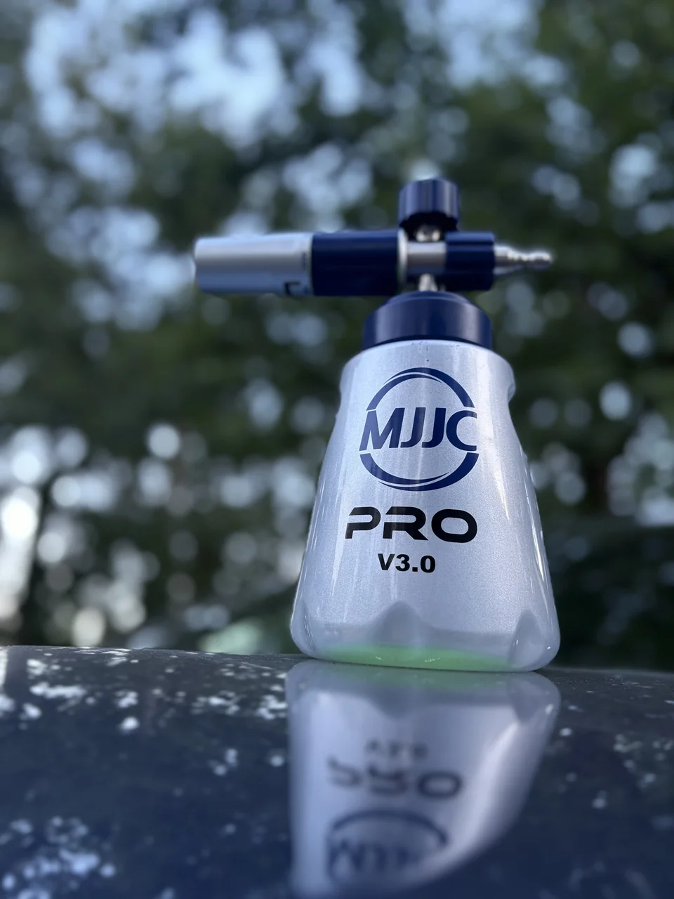 MJJC PRO V3.0 foam cannon reflected in a car hood